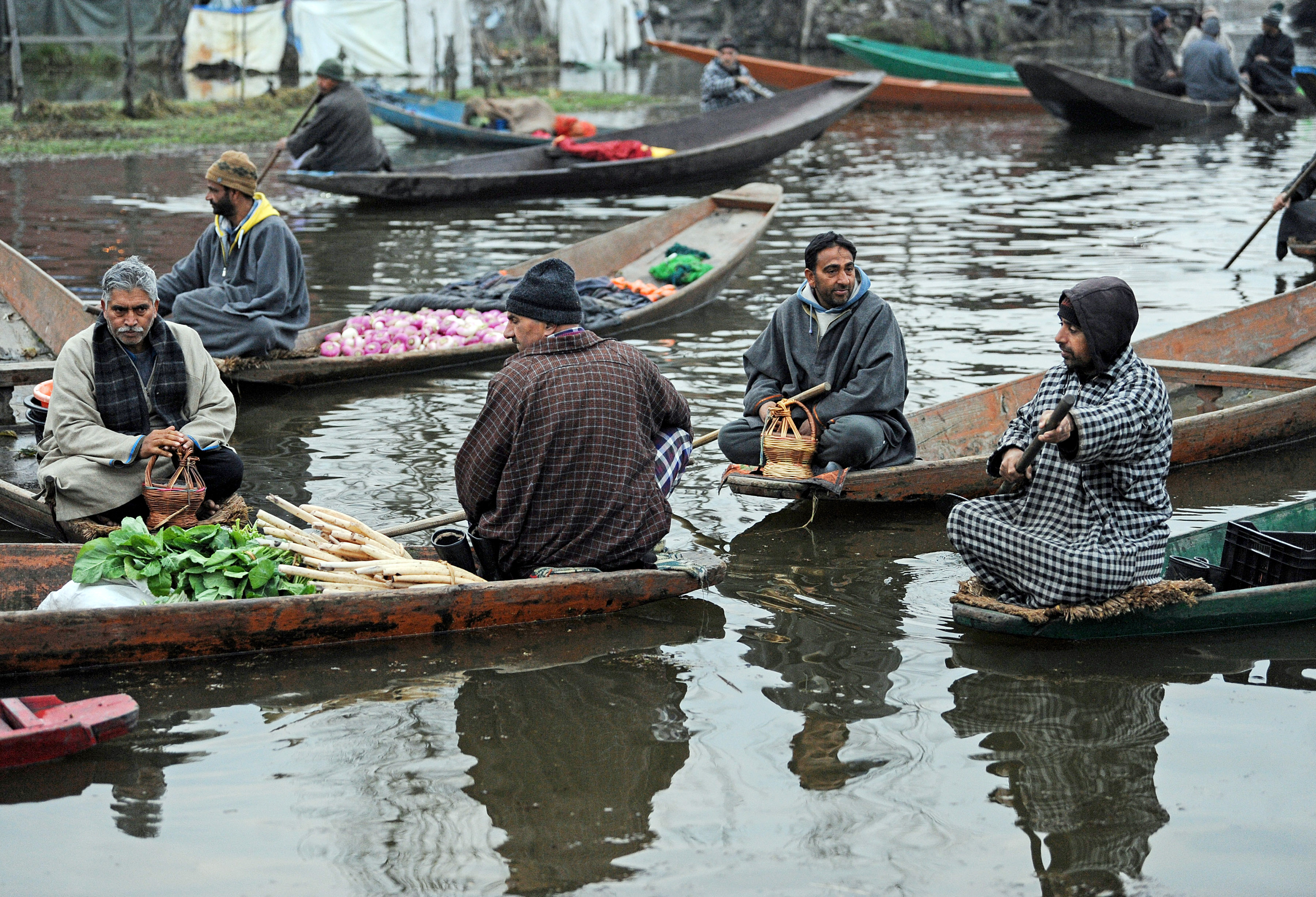 Vendors sell vegetables on a cold winter day