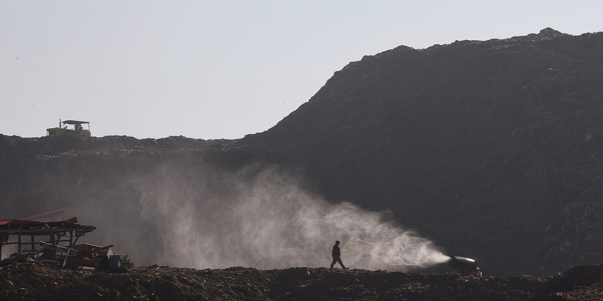 An Anti-smog gun sprays water at the Okhla land fill site