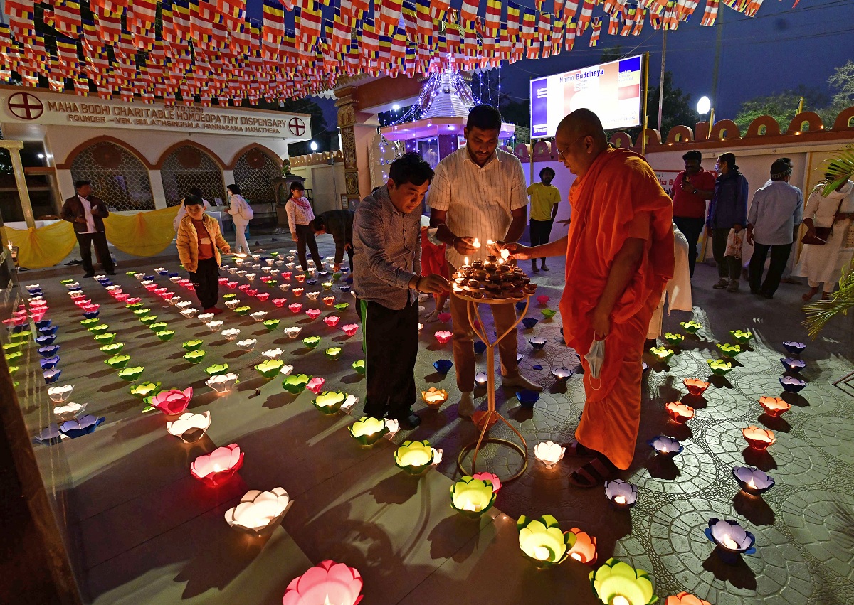 16th-anniversary celebration of Jaya Shree Maha Bodhi Vihara: Buddhist Monk lighting lamps