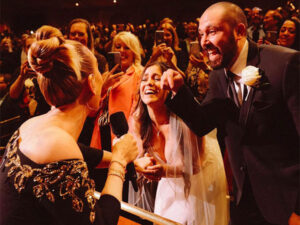 Adele signs a bride’s wedding dress during las vegas Show