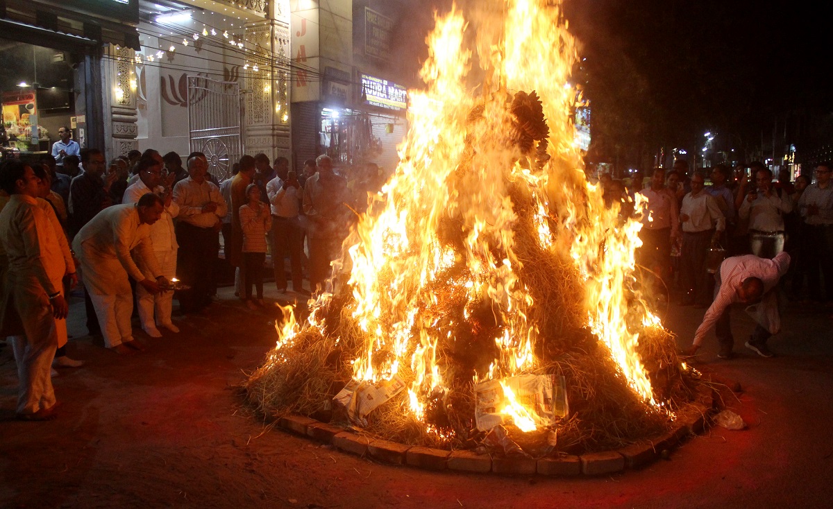 Devotees worship during the Holika Dahan