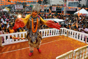 A devotee dressed as Lord Hanuman performs during the procession on the occasion of Ram Navami