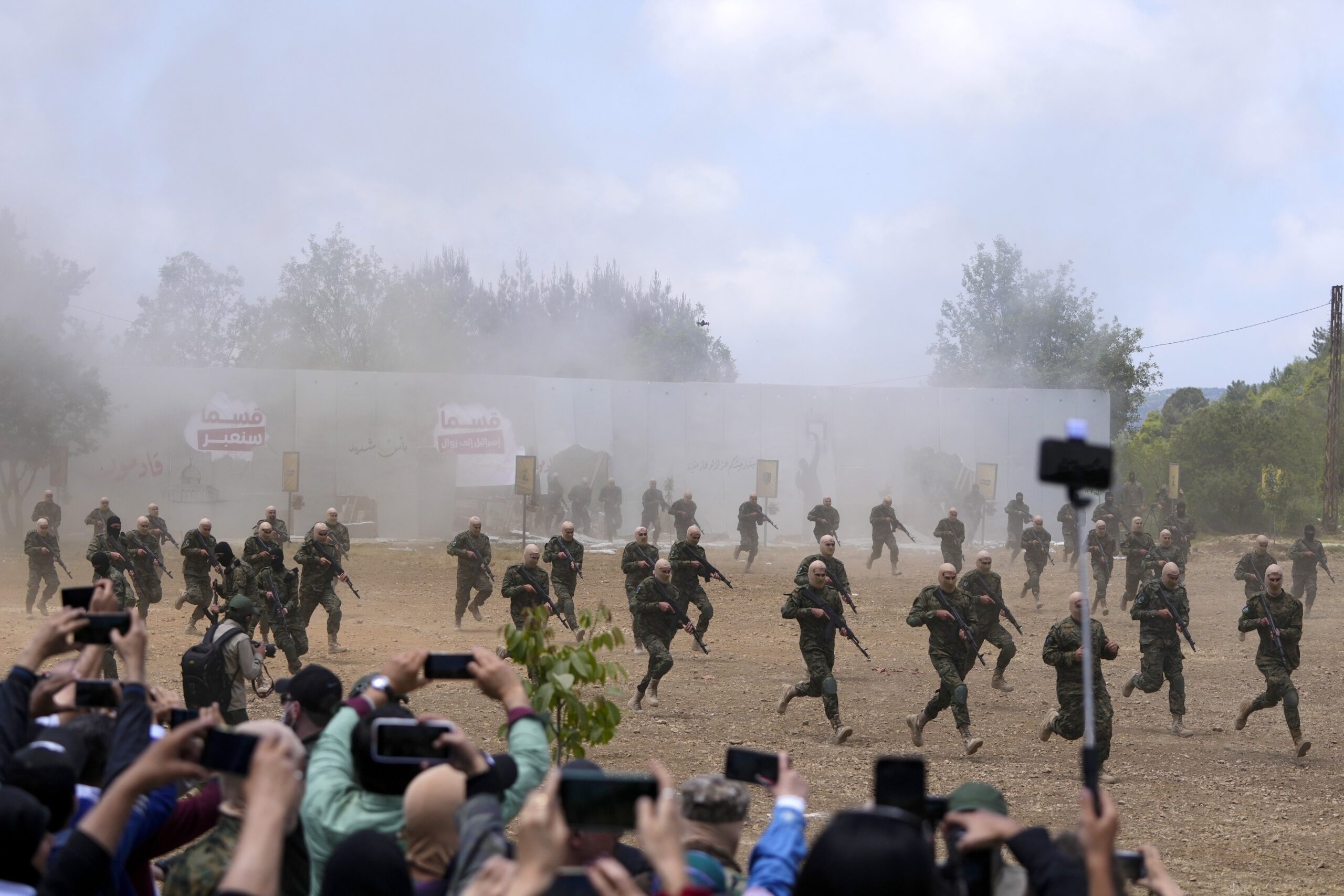 Fighters from the Lebanese militant group Hezbollah carry out a training exercise in Aaramta village in the Jezzine District, southern Lebanon on Sunday. For The Annual Celebration of ”Liberation Day”