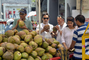 People drink coconut water to beat heat of hot summer day