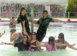 Women enjoy in a water park on a hot day in Bhopal