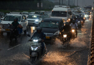 Commuters wade through the waterlogged Delhi-Gurugram Expressway