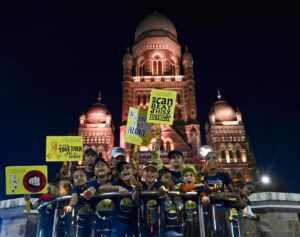 Cancer-affected children holding candles take part in an awareness campaign