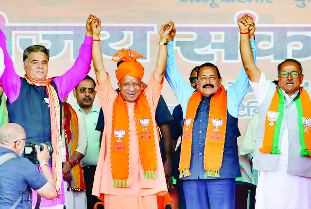 Uttar Pradesh Chief Minister Yogi Adityanath and Union Minister of State and BJP candidate Jitendra Singh during a public meeting for the Lok Sabha elections, in Kathua district.