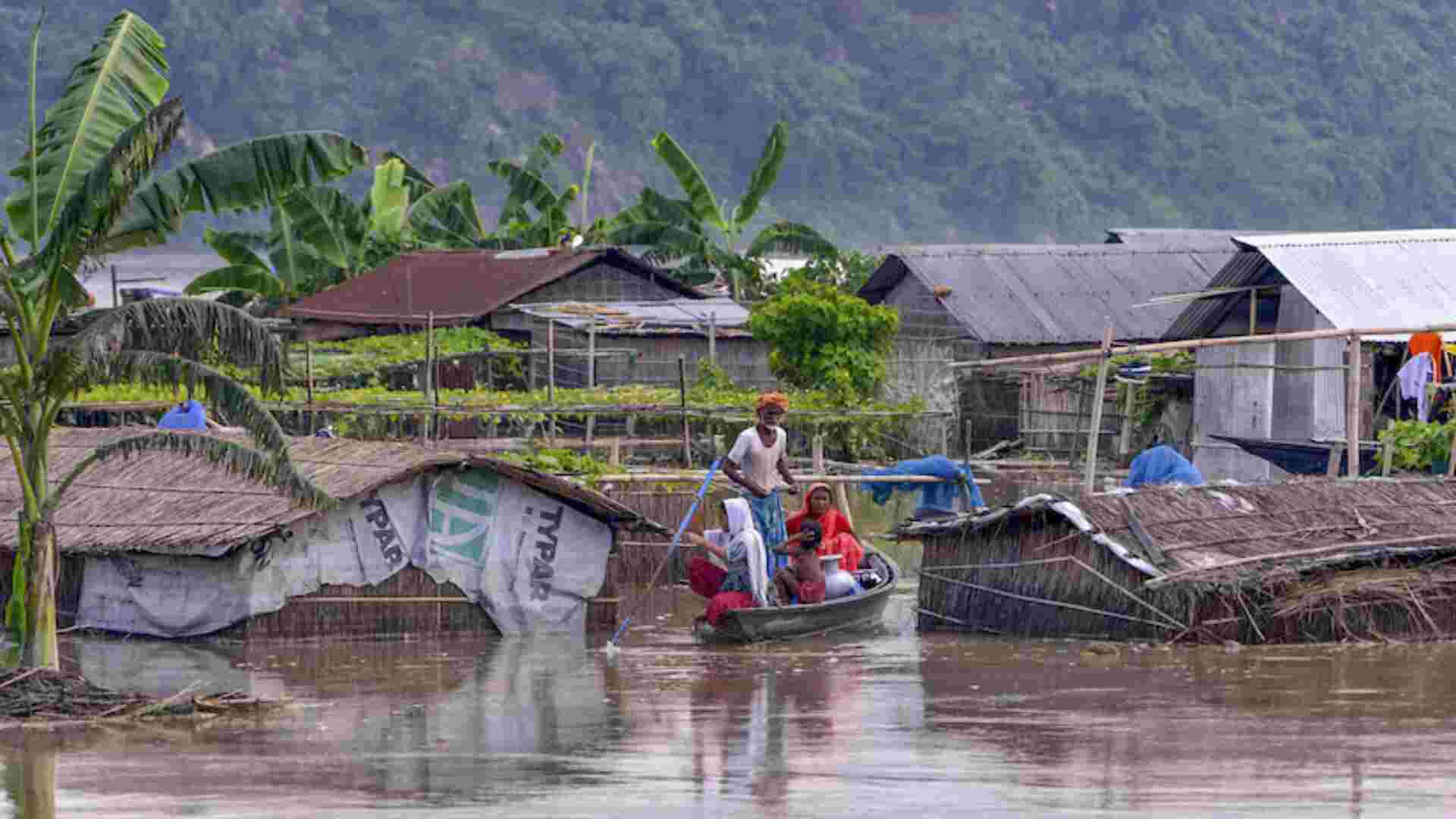 Assam Floods: Locals with their belongings on a boat