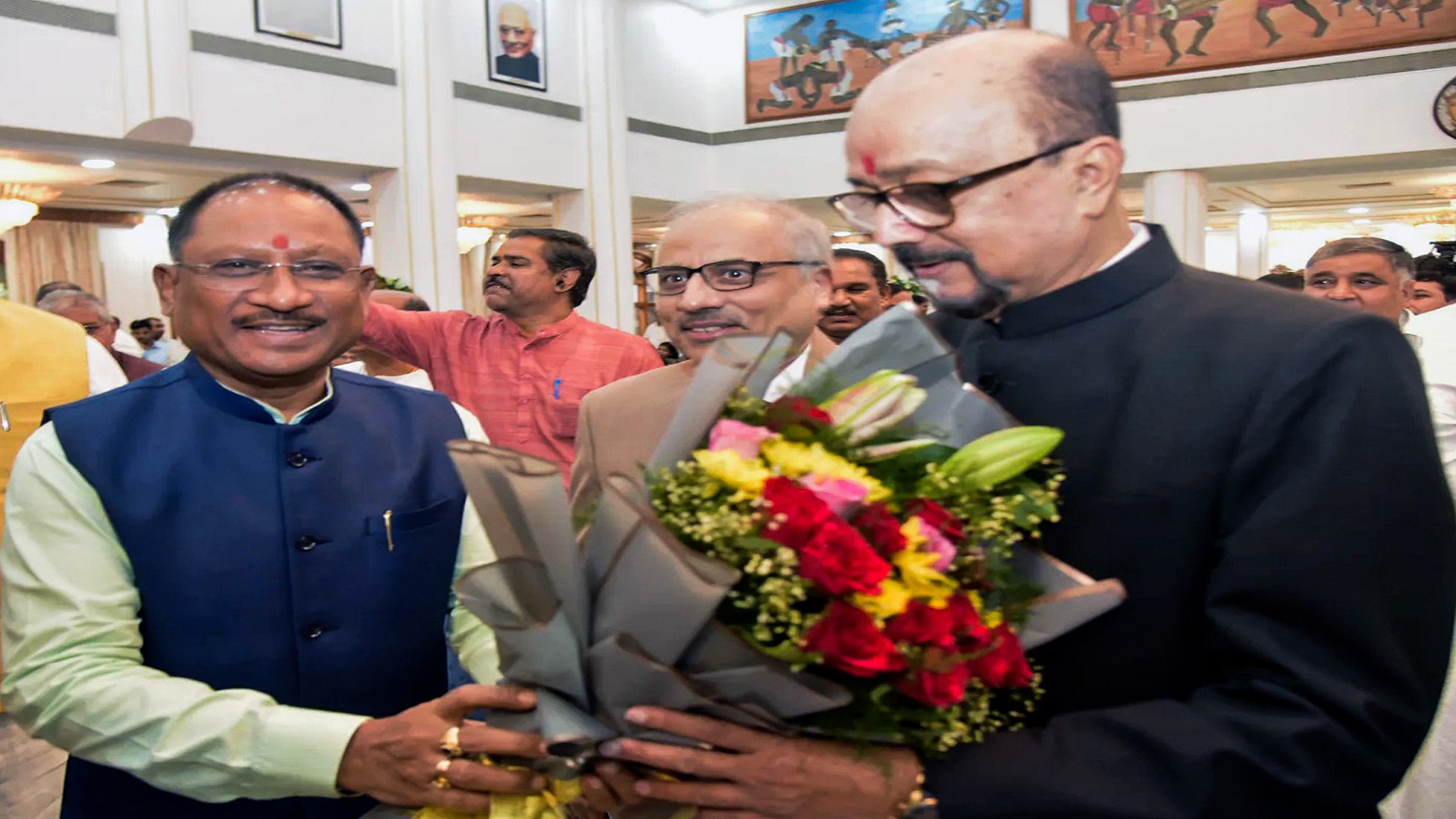 Chhattisgarh Chief Minister Vishnu Deo Sai congratulates the newly sworn-in State Governor Ramen Deka during a ceremony, at the Darbar Hall of the Raj Bhavan, in Raipur on Wednesday. (ANI Photo)