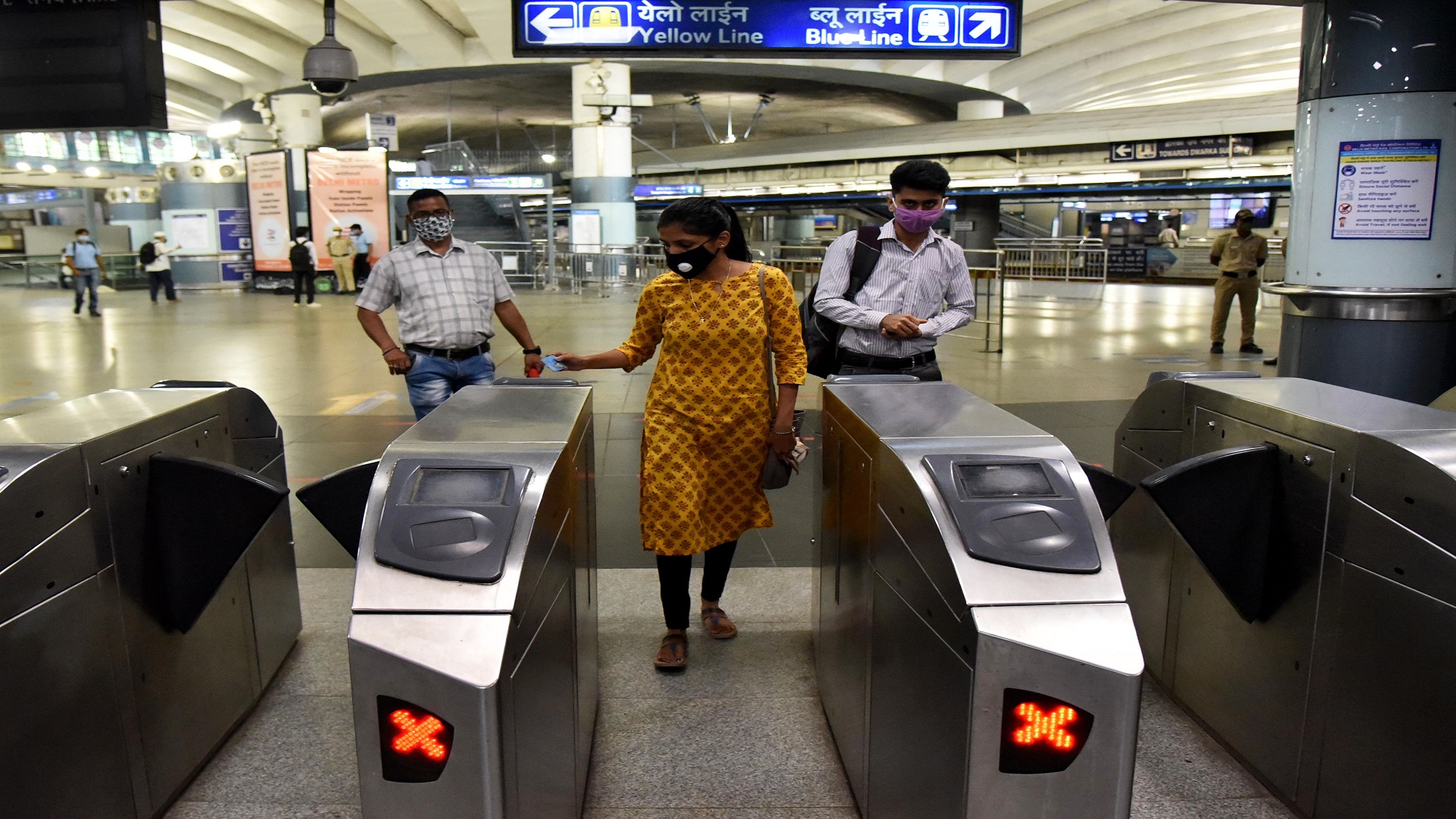 Commuters use smart cards while travelling in Yellow line of Delhi Metro.