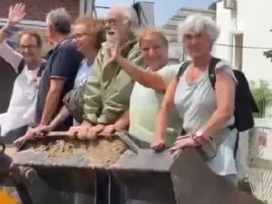 Bulldozer Joyride: Foreign Tourists Experience Unforgettable Rescue Amid Gujarat Floods – WATCH