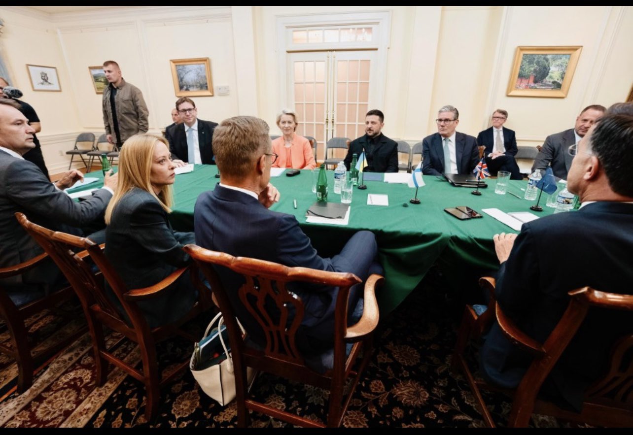 Zelenskyy in a formal suit shaking hands with Trump - Photo Gallery