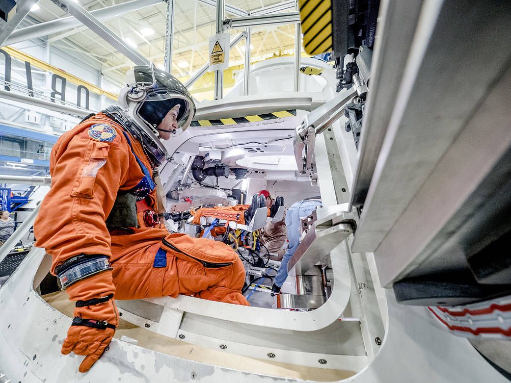Astronaut testing the life support system on a modern space suit. - Photo Gallery