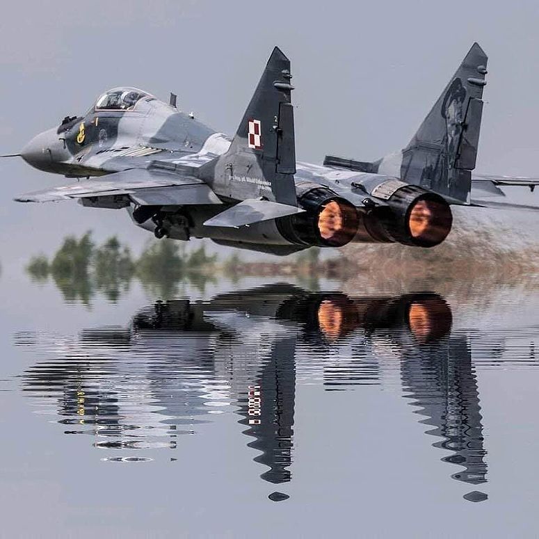 Engineers applying grey paint to a fighter jet - Photo Gallery