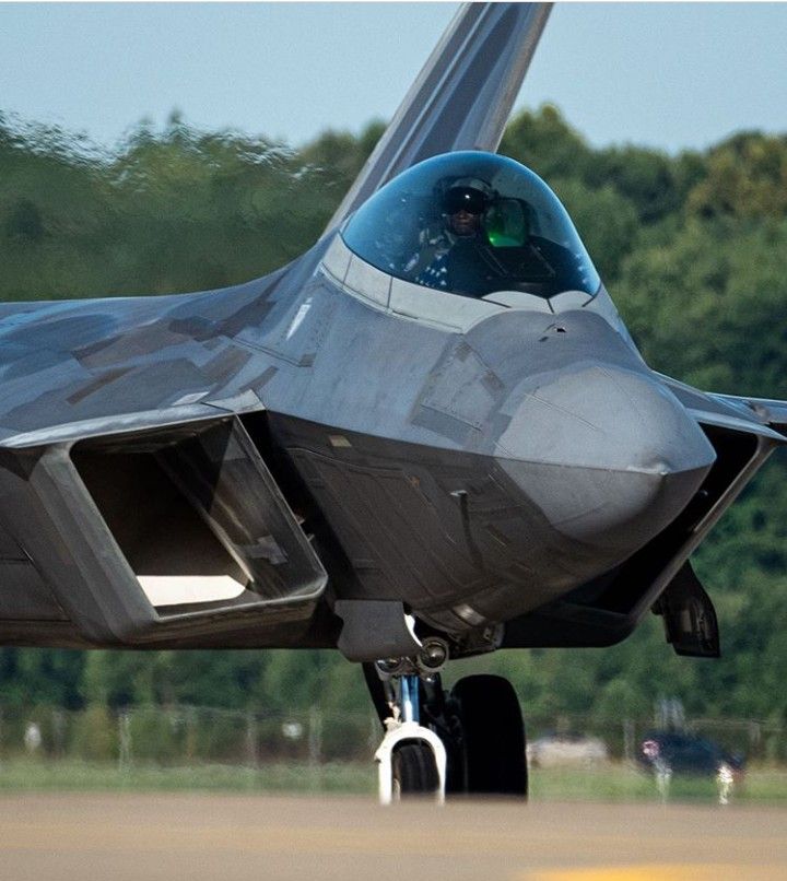 A grey fighter jet parked on a runway, ready for deployment. - Photo Gallery