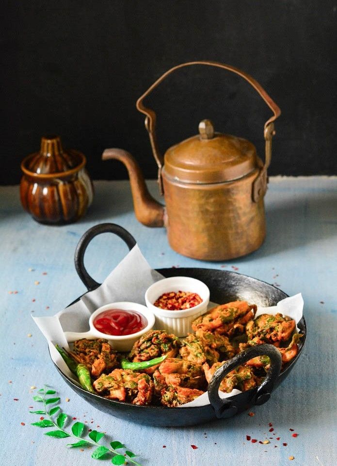 Golden pakoras with steaming masala chai a monsoon classic. - Photo Gallery