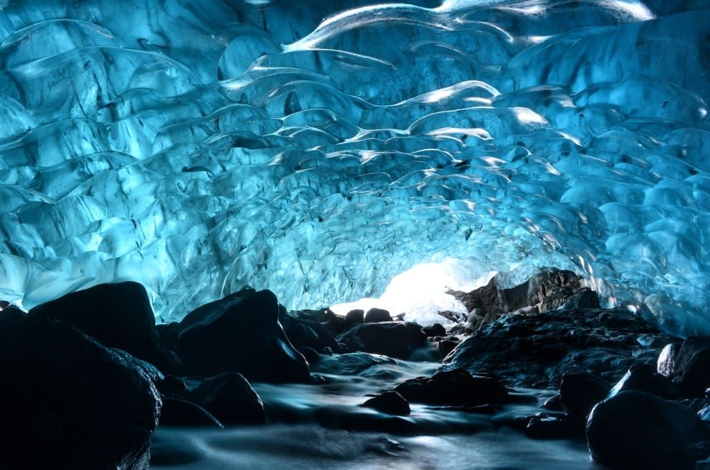 Inside Vatnajokull Glacier Cave with glowing blue ice - Photo Gallery