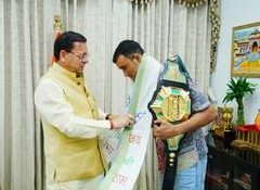 Uttarakhand CM Dhami felicitates MFN Lightweight World Champion Digambar Singh Rawat