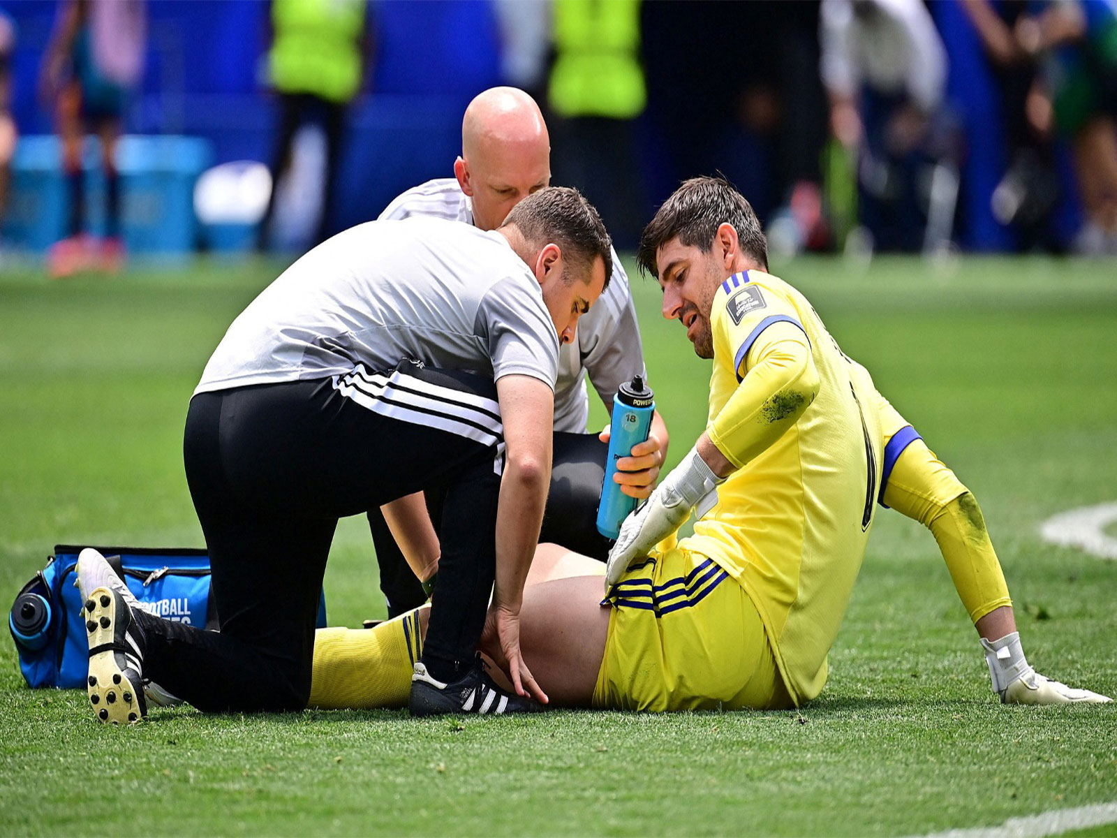 Belgium's Thibaut Courtois receives medical attention after sustaining an injury. (Photo: IMAGN IMAGES via Reuters)