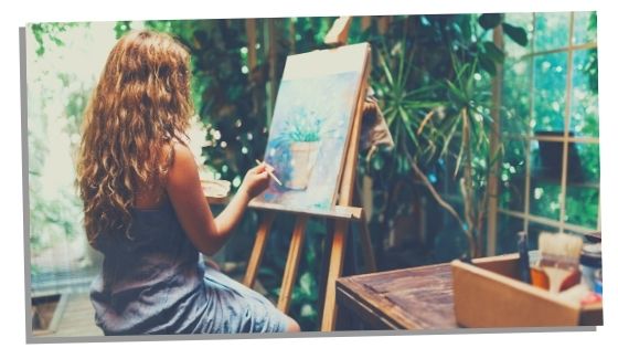 Woman practising self care by painting