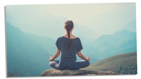 A Woman Sitting In Root Chakra Pose