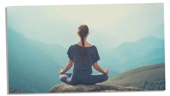 A Woman Sitting In Root Chakra Pose