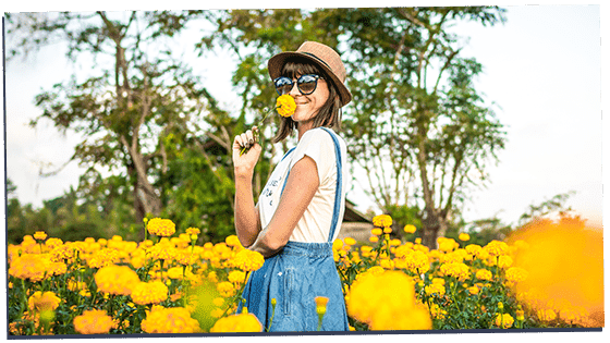 Image of a gamma female smelling flowers