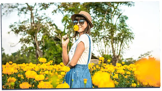 Image of a gamma female smelling flowers