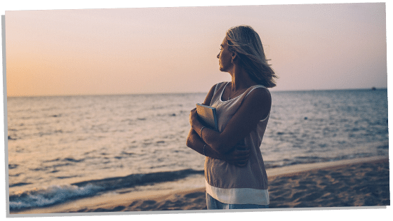 Image of woman holding a book thinking about her soulmate