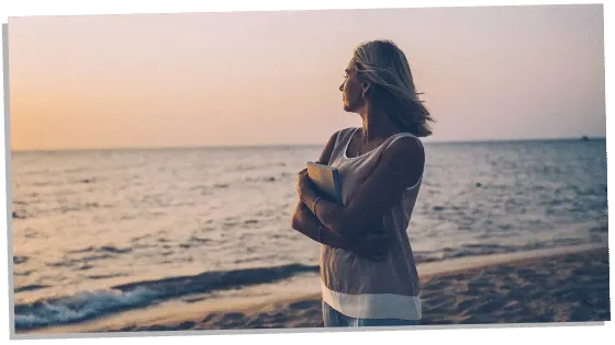 Image of woman holding a book thinking about her soulmate