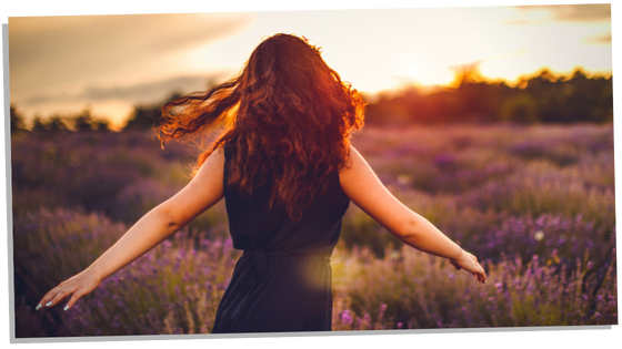 Woman in field letting go of the past