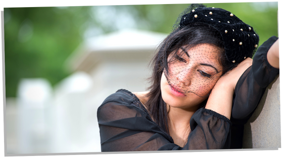 Woman dressed in black and grieving