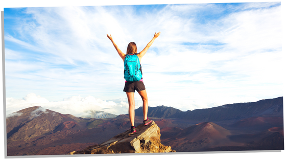 Woman feeling happy on top of the mountain