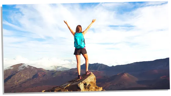 Woman feeling happy on top of the mountain