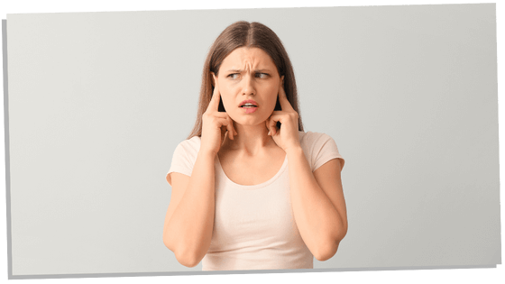 Image of a woman with fingers in ears representing the psychological facts about introverts