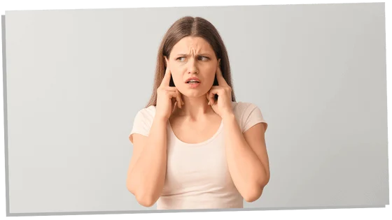 Image of a woman with fingers in ears representing the psychological facts about introverts