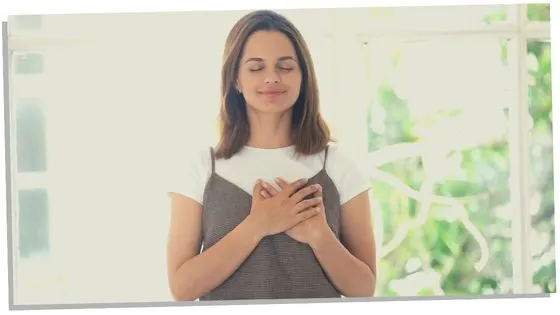 Image of a woman experiencing a physical symptoms of her heart chakra opening