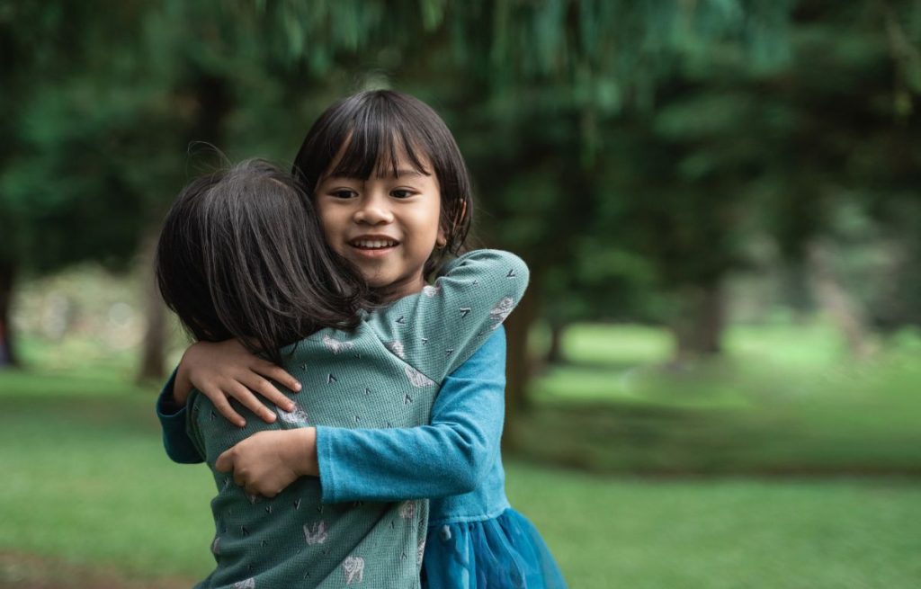 Children embracing each other 