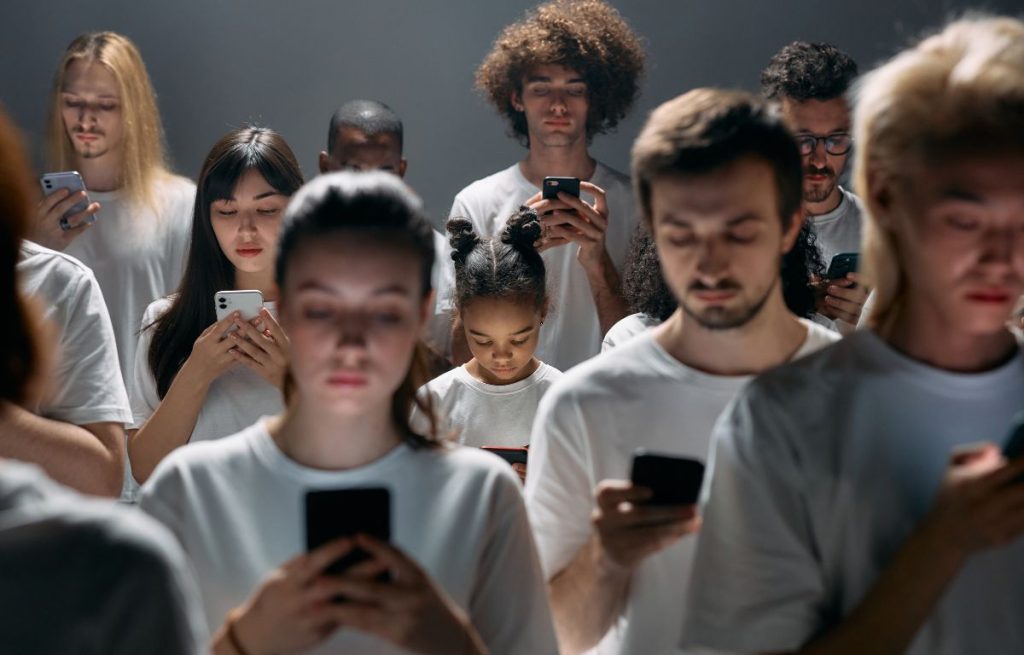 A group of people staring at their phones