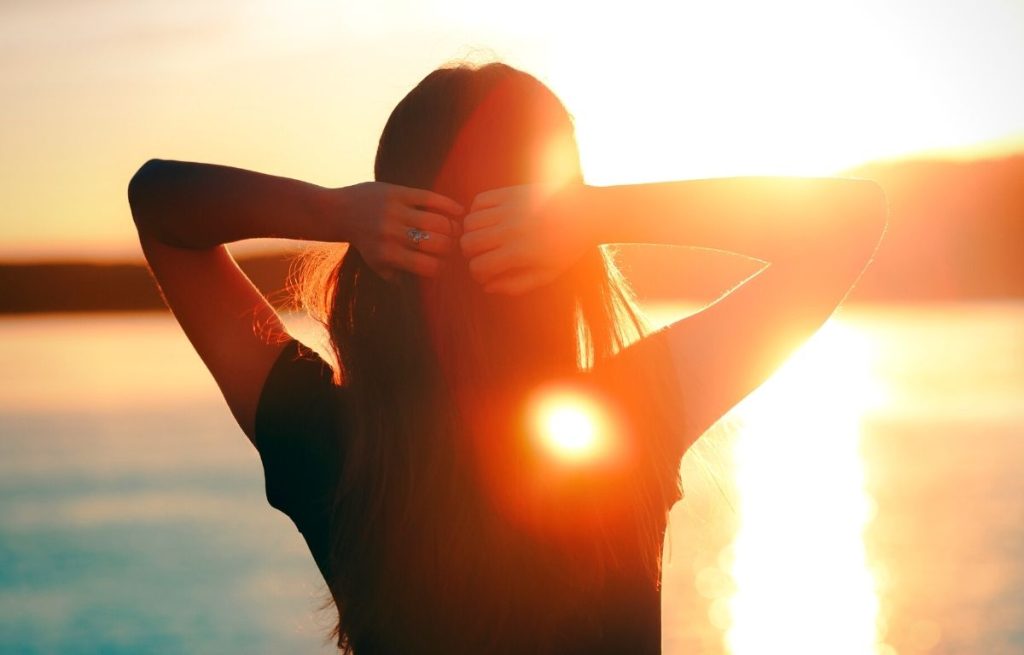 Hopeful woman relaxing at the sea