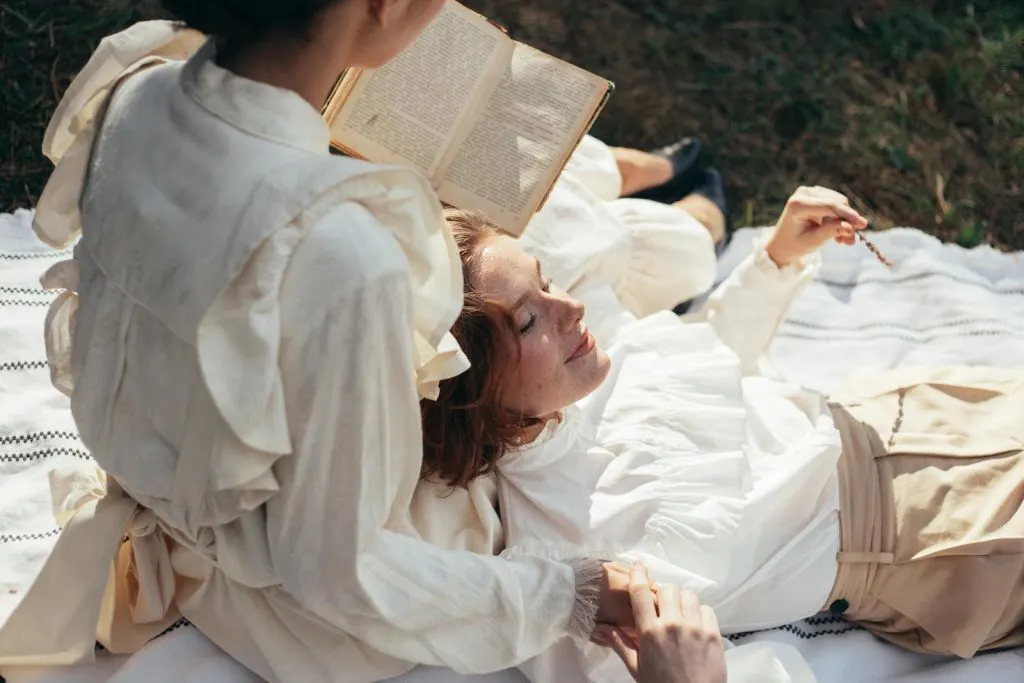 Women in Old-Fashioned Clothing on Picnic Blanket in Park